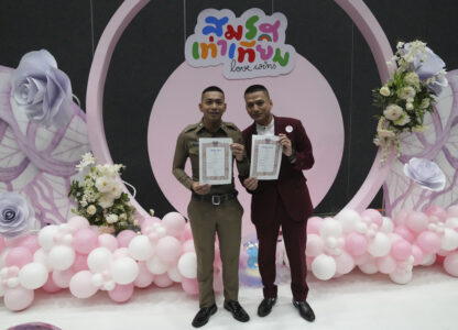 Pisit Sirihirunchai, left, and Chanatip Sirihirunchai from the LGBTQ+ community show their marriage certificates after the Marriage Equality Act took effect in Bangkok, Thailand, Thursday, Jan. 23, 2025. (AP Photo/Sakchai Lalit)