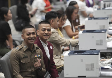 A couple from the LGBTQ+ community pose for a photo while waiting to sign their marriage certificates as the Marriage Equality Act takes effect in Bangkok, Thailand, Thursday, Jan. 23, 2025. (AP Photo/Sakchai Lalit)