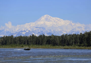 FILE - A boat is seen on the Susitna River near Talkeetna, Alaska, on Sunday, June 13, 2021, with Denali in the background. Denali, the tallest mountain on the North American continent, is located about 60 miles northwest of Talkeetna. (AP Photo/Mark Thiessen, File)