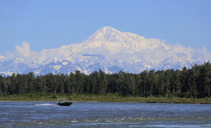 FILE - A boat is seen on the Susitna River near Talkeetna, Alaska, on Sunday, June 13, 2021, with Denali in the background. Denali, the tallest mountain on the North American continent, is located about 60 miles northwest of Talkeetna. (AP Photo/Mark Thiessen, File)