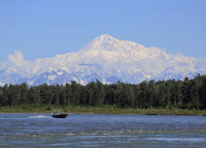 FILE - A boat is seen on the Susitna River near Talkeetna, Alaska, on Sunday, June 13, 2021, with Denali in the background. Denali, the tallest mountain on the North American continent, is located about 60 miles northwest of Talkeetna. (AP Photo/Mark Thiessen, File)