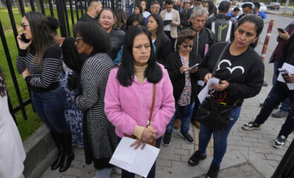 Gloria Camacho holds a notification stating her visa appointment was canceled, due to Colombian President Gustavo Petro's refusal to accept repatriation flights of Colombian citizens from the U.S., outside the U.S. embassy in Bogota, Colombia, Monday, Jan. 27, 2025. (AP Photo/Fernando Vergara)