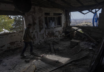 Igor Abramovich surveys heavy damage to a house from the 14-month war between Hezbollah and Israel in Kibbutz Manara, on the border with Lebanon, northern Israel, Jan. 5, 2025. (AP Photo/Ariel Schalit)