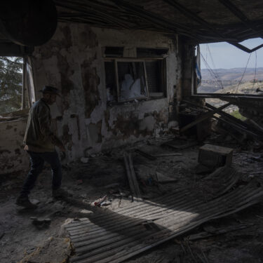 Igor Abramovich surveys heavy damage to a house from the 14-month war between Hezbollah and Israel in Kibbutz Manara, on the border with Lebanon, northern Israel, Jan. 5, 2025. (AP Photo/Ariel Schalit)