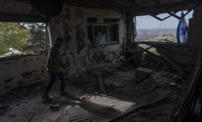 Igor Abramovich surveys heavy damage to a house from the 14-month war between Hezbollah and Israel in Kibbutz Manara, on the border with Lebanon, northern Israel, Jan. 5, 2025. (AP Photo/Ariel Schalit)