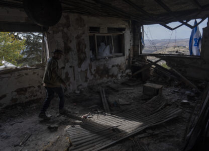 Igor Abramovich surveys heavy damage to a house from the 14-month war between Hezbollah and Israel in Kibbutz Manara, on the border with Lebanon, northern Israel, Jan. 5, 2025. (AP Photo/Ariel Schalit)