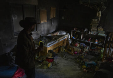 Igor Abramovich, surveys heavy damage to a children's room in a house from the 14-month war between Hezbollah and Israel in Kibbutz Manara, on the border with Lebanon, northern Israel, Jan. 5, 2025. (AP Photo/Ariel Schalit)