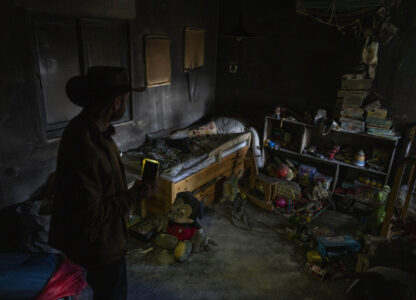 Igor Abramovich, surveys heavy damage to a children's room in a house from the 14-month war between Hezbollah and Israel in Kibbutz Manara, on the border with Lebanon, northern Israel, Jan. 5, 2025. (AP Photo/Ariel Schalit)