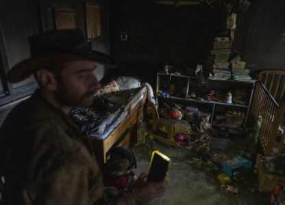 Igor Abramovich surveys heavy damage to a children's room in a house from the 14-month war between Hezbollah and Israel in Kibbutz Manara, on the border with Lebanon, northern Israel, Jan. 5, 2025. (AP Photo/Ariel Schalit)