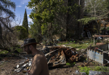 Igor Abramovich surveys heavy damage to a house from the 14-month war between Hezbollah and Israel in Kibbutz Manara, on the border with Lebanon, northern Israel, Jan. 5, 2025. (AP Photo/Ariel Schalit)