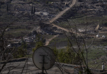 U.N. peacekeepers vehicles drive in the village of Meiss el-Jabal heavy damaged from the 14-month war between Hezbollah and Israel in southern Lebanon, as seen from a house in Kibbutz Manara, on the border with Lebanon, in northern Israel, Jan. 5, 2025. (AP Photo/Ariel Schalit)