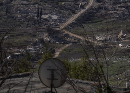 U.N. peacekeepers vehicles drive in the village of Meiss el-Jabal heavy damaged from the 14-month war between Hezbollah and Israel in southern Lebanon, as seen from a house in Kibbutz Manara, on the border with Lebanon, in northern Israel, Jan. 5, 2025. (AP Photo/Ariel Schalit)