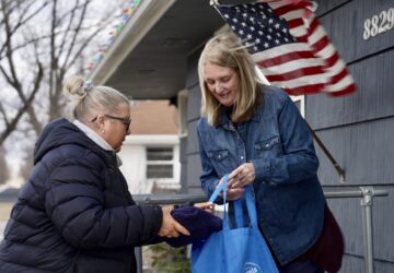 Bloomington and Eden Prairie Meals on Wheels Executive Director Wendy Vossen delivers meals for Barbara Teed and her adult son Ryan, who has Down syndrome, on Wednesday, Jan. 29, 2025, in Bloomington, Minn. (AP photo/Mark Vancleave)