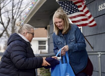 Bloomington and Eden Prairie Meals on Wheels Executive Director Wendy Vossen delivers meals for Barbara Teed and her adult son Ryan, who has Down syndrome, on Wednesday, Jan. 29, 2025, in Bloomington, Minn. (AP photo/Mark Vancleave)