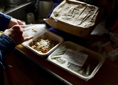 Barbara Teed unpacks a Meals on Wheels deliver for herself and her adult son Ryan, who has Down syndrome, on Wednesday, Jan. 29, 2025, in Bloomington, Minn. (AP photo/Mark Vancleave)