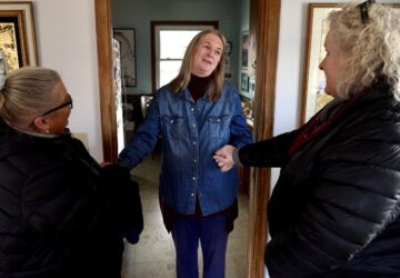 Barbara Teed thanks Jan Orcutt and Wendy Vossen for delivering food for herself and her adult son Ryan, who has Down syndrome, on Wednesday, Jan. 29, 2025, in Bloomington, Minn. (AP photo/Mark Vancleave)