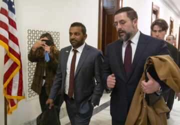 FILE - Kash Patel, President-elect Donald Trump's pick to be the director of the FBI, center, walks between meetings on Capitol Hill, Monday, Dec. 9, 2024, in Washington. (AP Photo/Mark Schiefelbein, File)