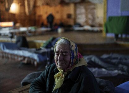 Kateryna Odraha, 83, cries after evacuation from the frontline village Andiivka, Donetsk region at a center for displaced people in Pavlohrad, Ukraine, Saturday, Feb. 1, 2024. (AP Photo/Evgeniy Maloletka)