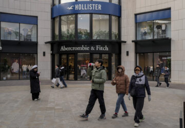 Chinese shoppers tour past American fashion boutiques at an outdoor shopping mall in Beijing, Tuesday, Feb. 4, 2025. (AP Photo/Andy Wong)