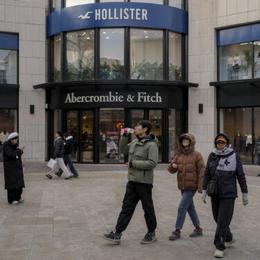 Chinese shoppers tour past American fashion boutiques at an outdoor shopping mall in Beijing, Tuesday, Feb. 4, 2025. (AP Photo/Andy Wong)