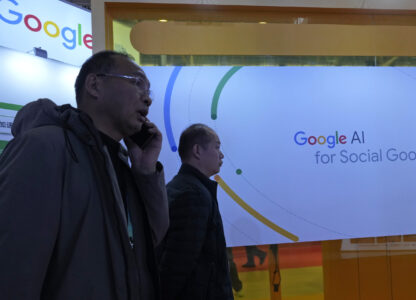 Visitors past by a Google booth promoting Artificial Intelligence at a supply chain expo in Beijing, Wednesday, Nov. 27, 2024. (AP Photo/Ng Han Guan)