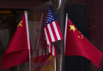 China and U.S. national flags are seen on display outside a souvenir shop in Beijing on Jan. 31, 2025. (AP Photo/Andy Wong)