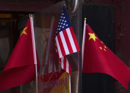 China and U.S. national flags are seen on display outside a souvenir shop in Beijing on Jan. 31, 2025. (AP Photo/Andy Wong)