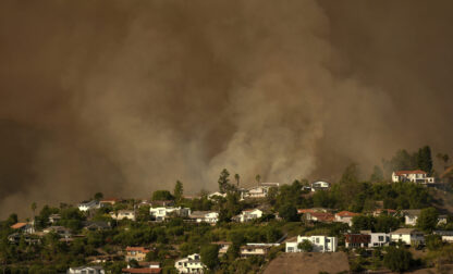 FILE - Smoke from the Palisades Fire rises over residences in Mandeville Canyon Saturday, Jan. 11, 2025, in Los Angeles. (AP Photo/Jae C. Hong, File)