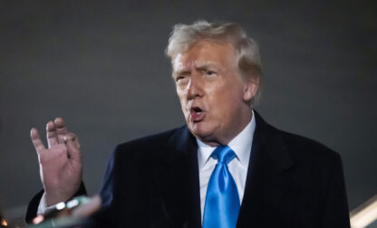 President Donald Trump speaks to reporters next to Air Force One after arriving back at Joint Base Andrews, Md., Sunday, Feb. 2, 2025. (AP Photo/Ben Curtis)