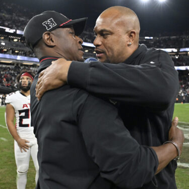 FILE - Las Vegas Raiders head coach Antonio Pierce, right, greets Atlanta Falcons head coach Raheem Morris, left, after an NFL football game Dec. 16, 2024, in Las Vegas. (AP Photo/David Becker, File)