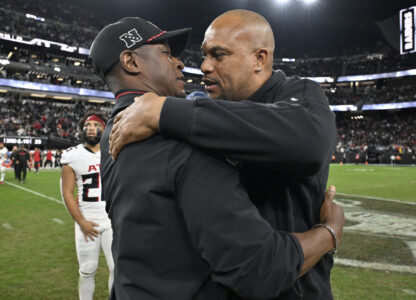 FILE - Las Vegas Raiders head coach Antonio Pierce, right, greets Atlanta Falcons head coach Raheem Morris, left, after an NFL football game Dec. 16, 2024, in Las Vegas. (AP Photo/David Becker, File)