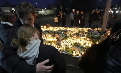 People take part in a vigil near the scene of a shooting at an adult education center on the outskirts of Orebro, Sweden, Thursday, Feb. 6, 2025. (AP Photo/Sergei Grits)