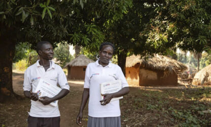 This photo provided by World Relief shows care group volunteers Neimate Mustafa and John Simon Mbiliwele, who provide community health education, visiting a homestead in January 2022, in Maridi, South Sudan. (Esther Mbabazi/World Relief via AP)