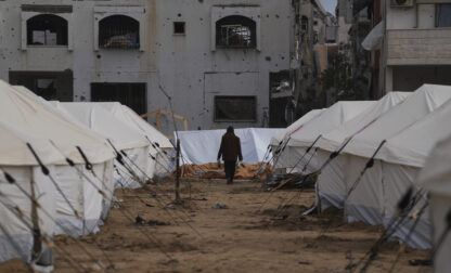 FILE - A man walks between tents for displaced Palestinians next to destroyed buildings following the Israeli air and ground offensive in Jabaliya, Gaza Strip, Thursday, Feb. 6, 2025. (AP Photo/Abdel Kareem Hana, file)