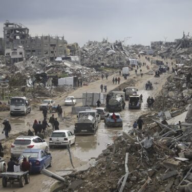 FILE - Cars and pedestrians move along a road amid widespread destruction caused by the Israeli military's ground and air offensive against Hamas in Gaza City's Jabaliya refugee camp, Friday, Feb. 7, 2025. (AP Photo/Jehad Alshrafi, file)