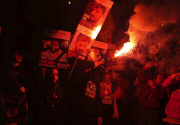 Relatives of hostages, held by Hamas in the Gaza Strip, protest outside of Israel's Ministry of Defense in Tel Aviv, Monday, Feb. 10, 2025, after the militant group announced it would delay hostage releases in the Gaza Strip after accusing Israel of violating a fragile ceasefire. (AP Photo/Ohad Zwigenberg)