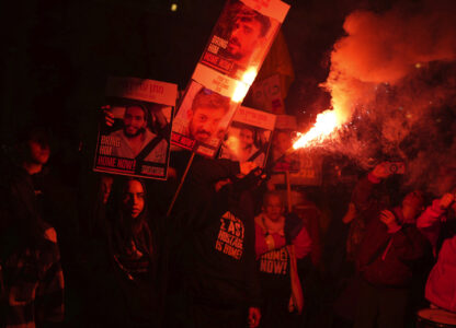 Relatives of hostages, held by Hamas in the Gaza Strip, protest outside of Israel's Ministry of Defense in Tel Aviv, Monday, Feb. 10, 2025, after the militant group announced it would delay hostage releases in the Gaza Strip after accusing Israel of violating a fragile ceasefire. (AP Photo/Ohad Zwigenberg)