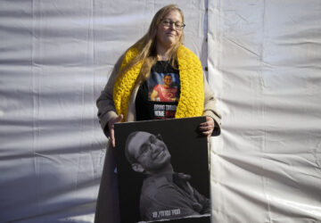 FILE - Herut Nimrodi poses for a portrait with a poster of her son, Tamir Nimrodi, an Israeli soldier taken hostage on Oct. 7, 2023, and being held by Hamas militants in the Gaza Strip, at a rally for hostages and their families in Tel Aviv, Israel, Jan. 14, 2025. (AP Photo/Maya Alleruzzo, File)