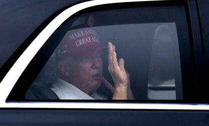 President Donald Trump waves from his vehicle as he arrives at the Trump International Golf Club, Monday, Feb. 17, 2025, in West Palm Beach, Fla. (AP Photo/Ben Curtis)