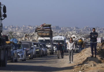 Displaced Palestinians, traveling in vehicles, wait to cross through a security checkpoint at the Netzarim corridor as they make their way from central Gaza to the northern Gaza Strip, Tuesday, Feb. 18, 2025. (AP Photo/Abdel Kareem Hana)