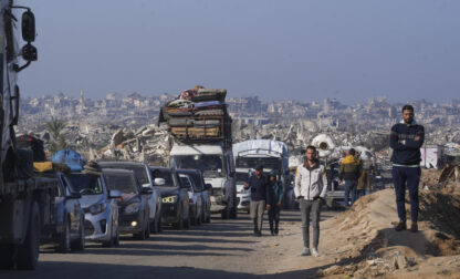 Displaced Palestinians, traveling in vehicles, wait to cross through a security checkpoint at the Netzarim corridor as they make their way from central Gaza to the northern Gaza Strip, Tuesday, Feb. 18, 2025. (AP Photo/Abdel Kareem Hana)