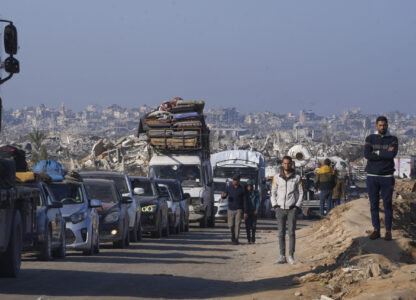 Displaced Palestinians, traveling in vehicles, wait to cross through a security checkpoint at the Netzarim corridor as they make their way from central Gaza to the northern Gaza Strip, Tuesday, Feb. 18, 2025. (AP Photo/Abdel Kareem Hana)