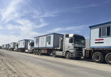 Scores of trucks carrying mobile homes line up on the Egyptian side of the Rafah crossing in preparation for entering Gaza, at the Rafah border crossing, Egypt, Tuesday, Feb. 18, 2025. (AP Photo/Mayar Mokhtar)