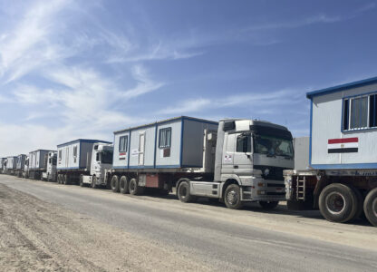 Scores of trucks carrying mobile homes line up on the Egyptian side of the Rafah crossing in preparation for entering Gaza, at the Rafah border crossing, Egypt, Tuesday, Feb. 18, 2025. (AP Photo/Mayar Mokhtar)