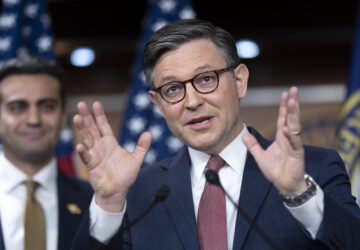 Speaker of the House Mike Johnson, R-La., joined at left by Rep. Abraham Hamadeh, R-Ariz., praises President Donald Trump as he describes the sight of the president on the giant video screens during the Super Bowl, at a news conference at the Capitol in Washington, Tuesday, Feb. 11, 2025. (AP Photo/J. Scott Applewhite)