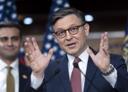 Speaker of the House Mike Johnson, R-La., joined at left by Rep. Abraham Hamadeh, R-Ariz., praises President Donald Trump as he describes the sight of the president on the giant video screens during the Super Bowl, at a news conference at the Capitol in Washington, Tuesday, Feb. 11, 2025. (AP Photo/J. Scott Applewhite)