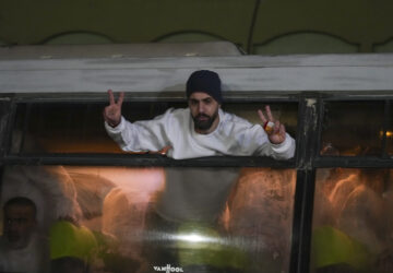 Freed Palestinian prisoners wave from a bus as they arrive in the Gaza Strip after being released from an Israeli prison following a ceasefire agreement between Hamas and Israel in Khan Younis, Gaza Strip, Thursday, Feb. 27, 2025. (AP Photo/Abdel Kareem Hana)