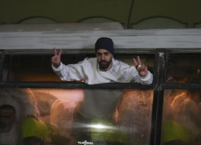 Freed Palestinian prisoners wave from a bus as they arrive in the Gaza Strip after being released from an Israeli prison following a ceasefire agreement between Hamas and Israel in Khan Younis, Gaza Strip, Thursday, Feb. 27, 2025. (AP Photo/Abdel Kareem Hana)