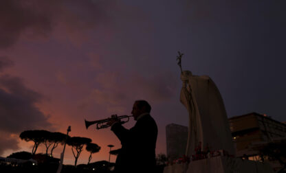 Trumpeter Felice Carella is silhouetted as he plays the song Ave Maria for Pope Francis in front of the Agostino Gemelli Polyclinic, where the Pontiff has been hospitalized since Feb. 14, in Rome, Wednesday, Feb. 26, 2025. (AP Photo/Kirsty Wigglesworth)