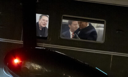 FILE - Elon Musk, left, and President Donald Trump, right, are seen through the windows as Marine One lands on the South Lawn of the White House, Feb. 19, 2025, in Washington. (AP Photo/Alex Brandon, File)